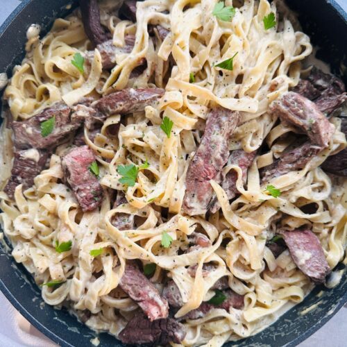 creamy steak pasta in a pan