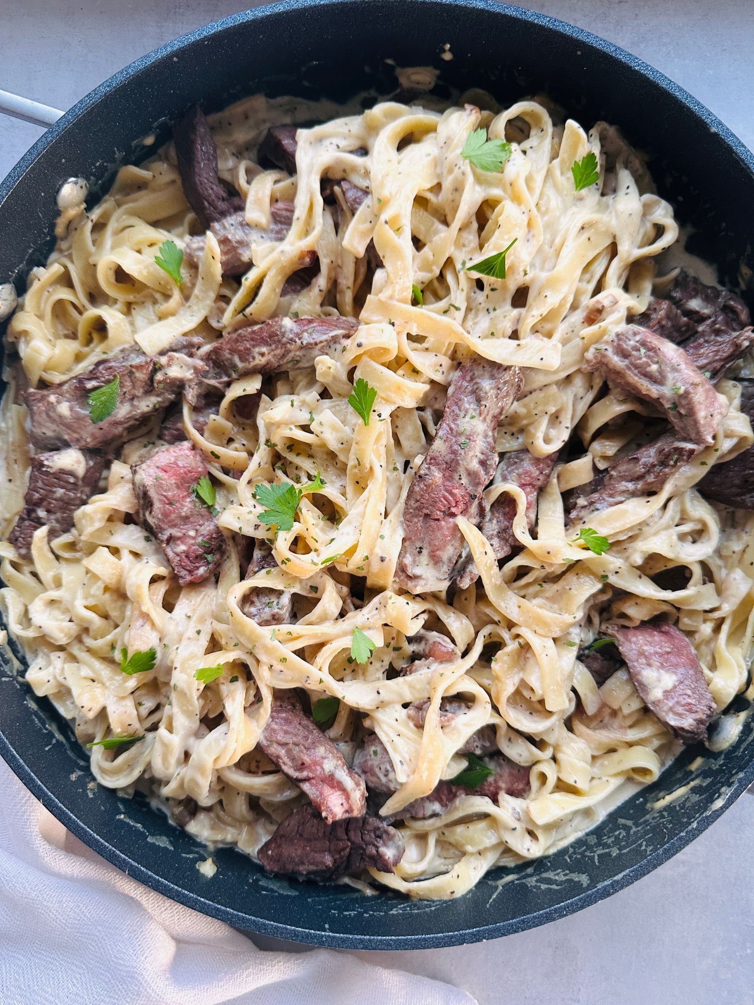 creamy steak pasta in a pan
