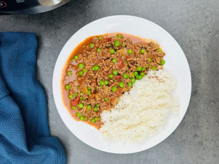 curried mince with peas on a plate next to Ninja Foodi 15 in 1