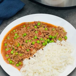 curried mince on a plate next to a Ninja Foodi 15 in 1