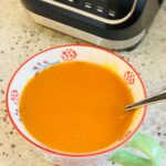 spicy tomato soup next to Ninja soup maker