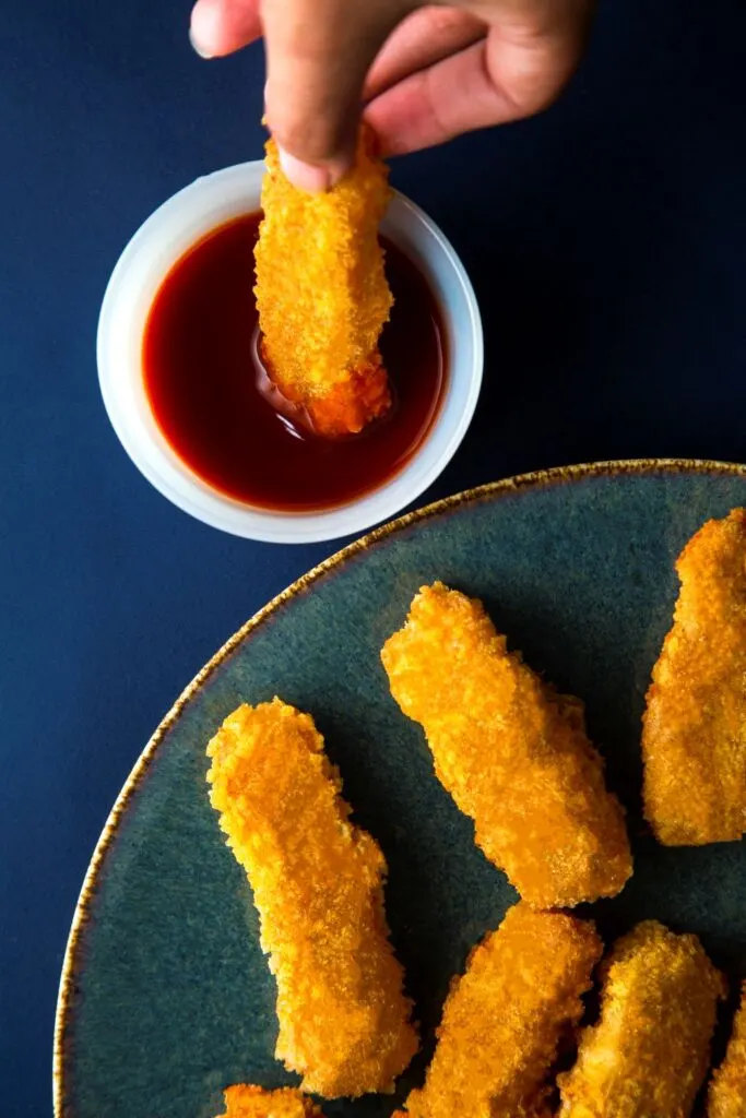 Halloumi Fries halloumi fries being dipped into a sauce