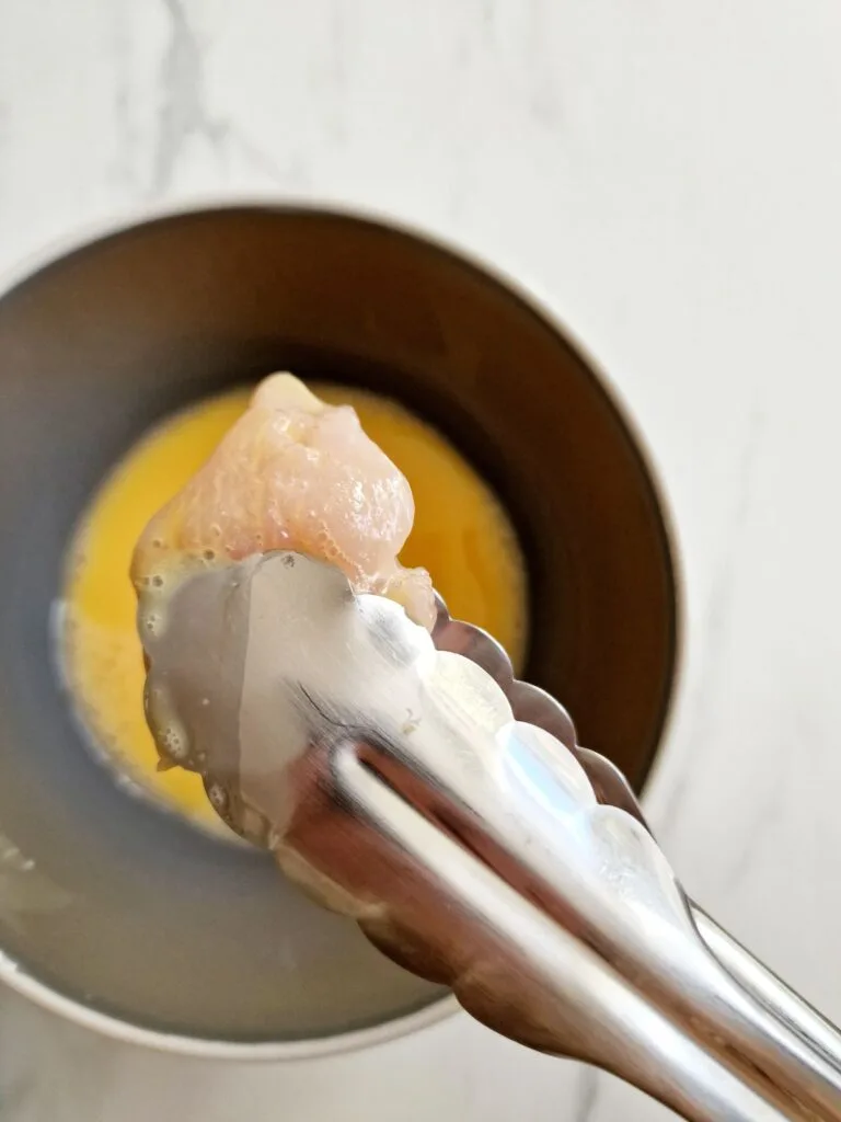 dipping egg in chicken