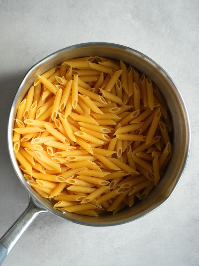 dried penne pasta in a saucepan