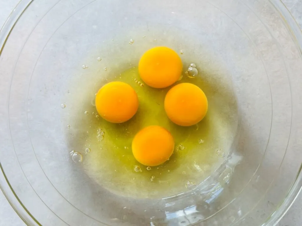 4 egg yolks in mixing bowl 