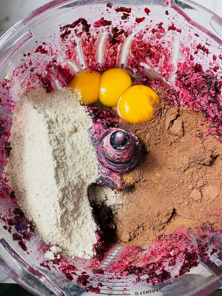 eggs, flour, cocoa powder in food processor with beetroot mixture for brownies