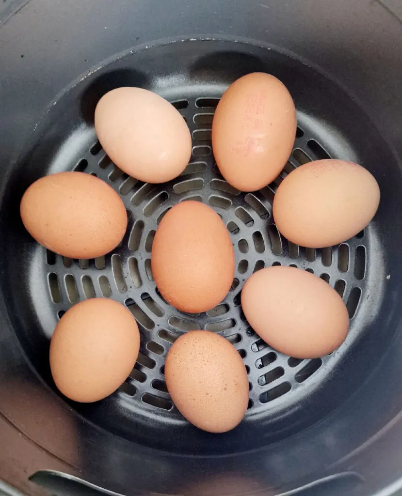 eggs in the air fryer basket ready to cook