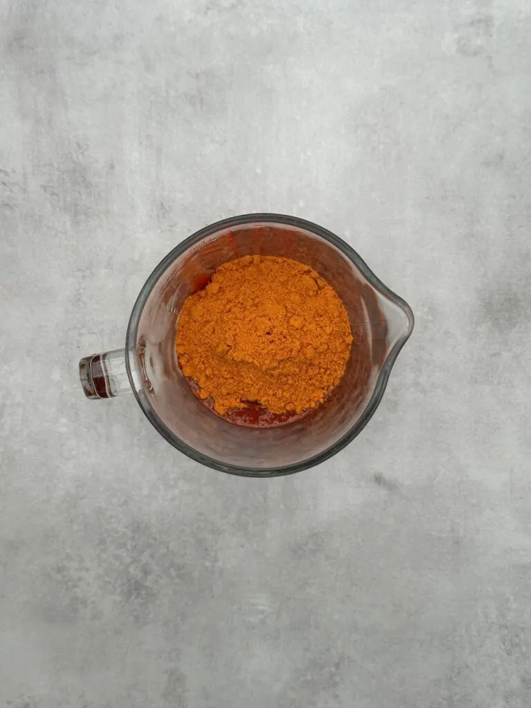 chopped tomatoes and fajita spice mix in a pyrex jug