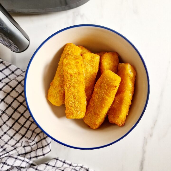 fish fingers in bowl next to the air fryer