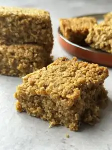 flapjack slice on table in front of other flapjacks