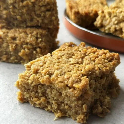 flapjack slice on table in front of other flapjacks