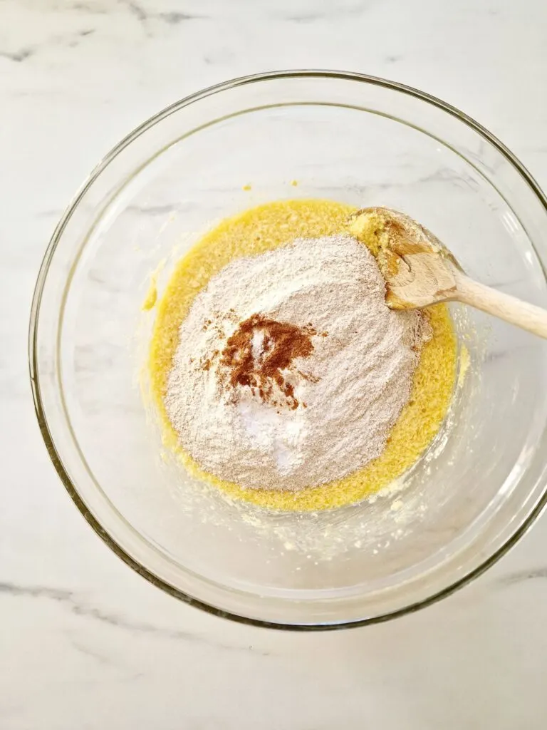 flour, cinnamon, baking powder in egg sugar butter