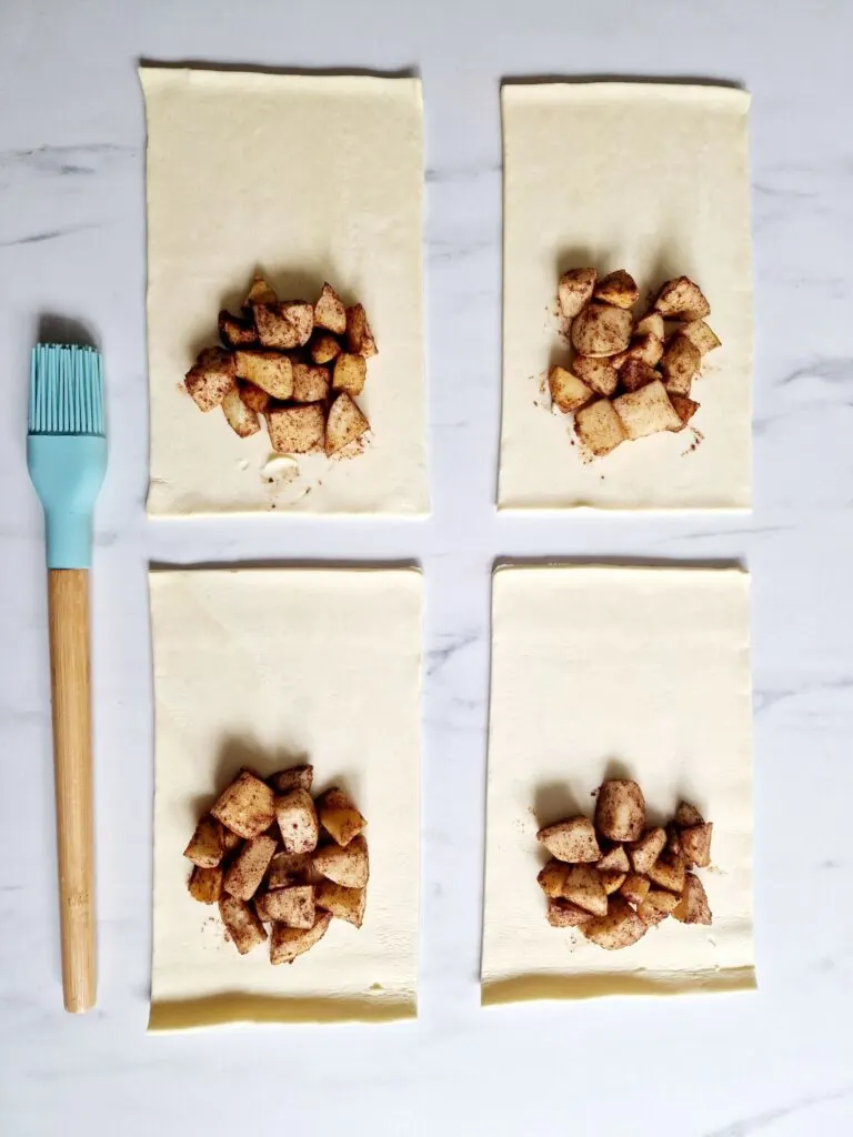 puff pastry rectangles with apple and cinnamon filling on each one