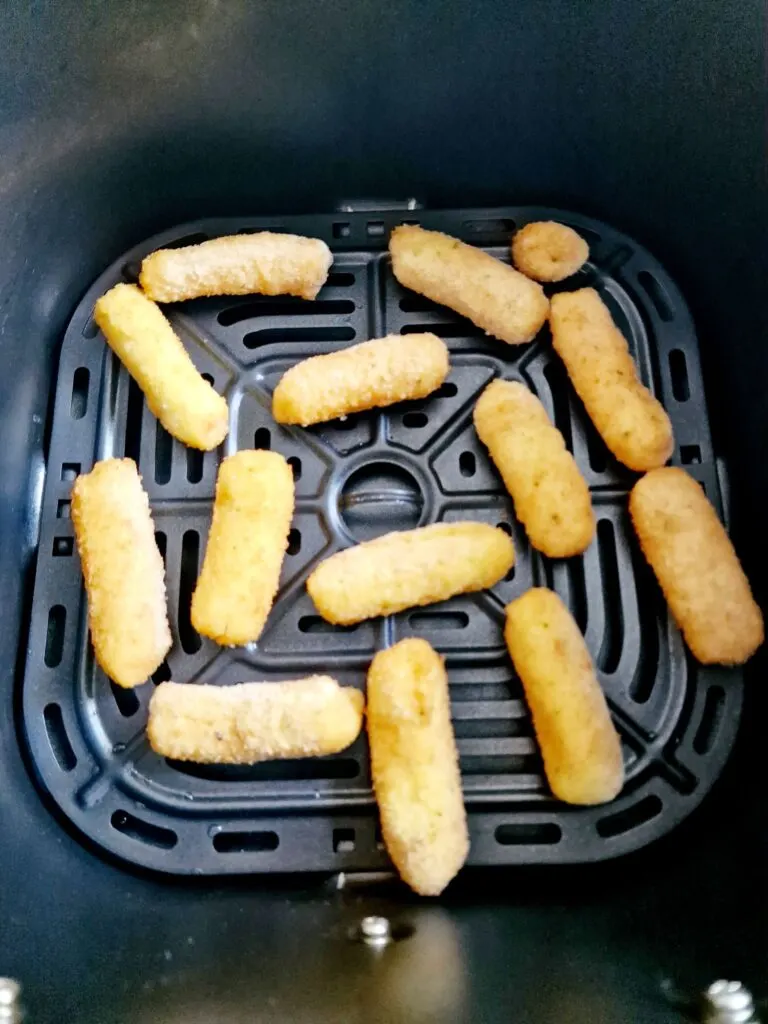 frozen Mozzarella Sticks in air fryer basket