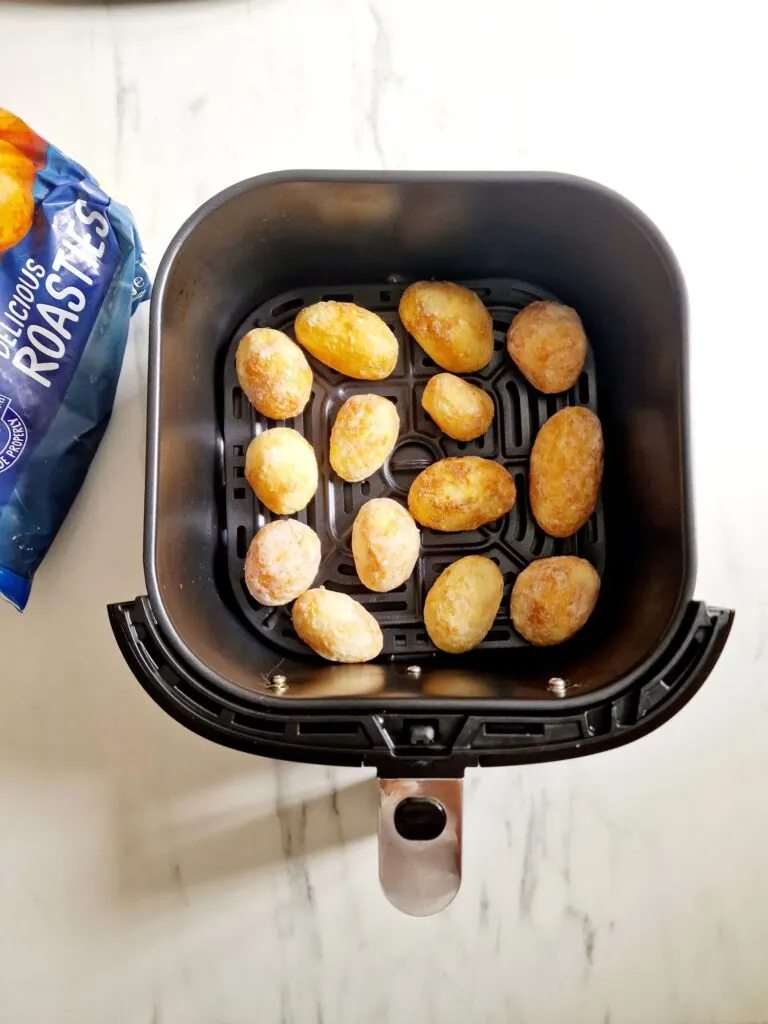 frozen roast potatoes in an air fryer basket