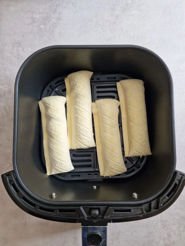 4 frozen sausage rolls in air fryer basket