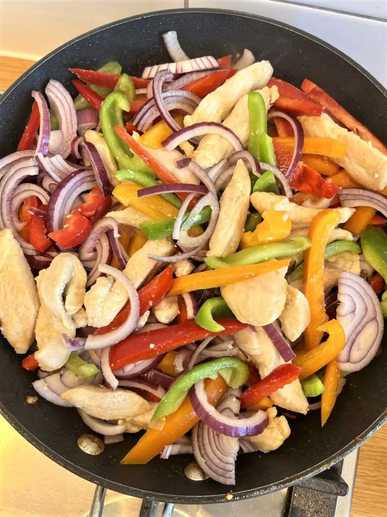 chicken fajitas ingredients in a frying pan