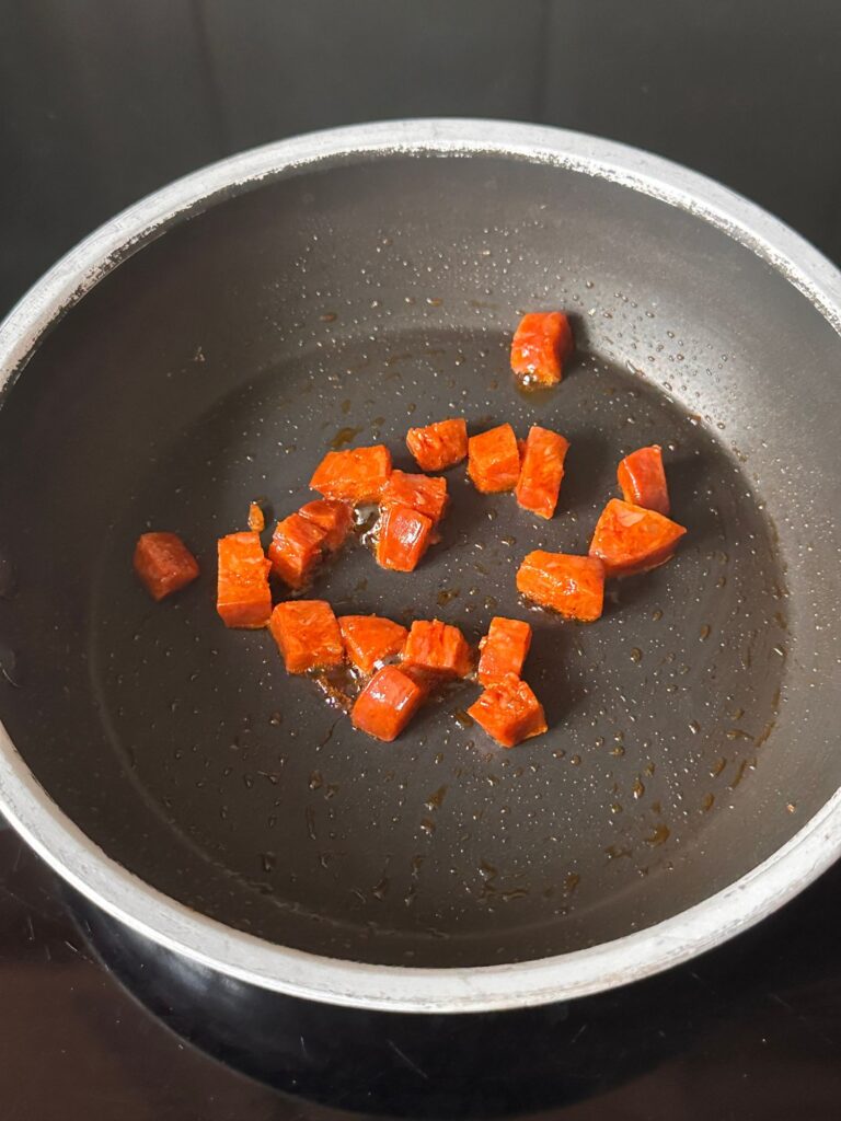 chopped chorizo in small pan frying