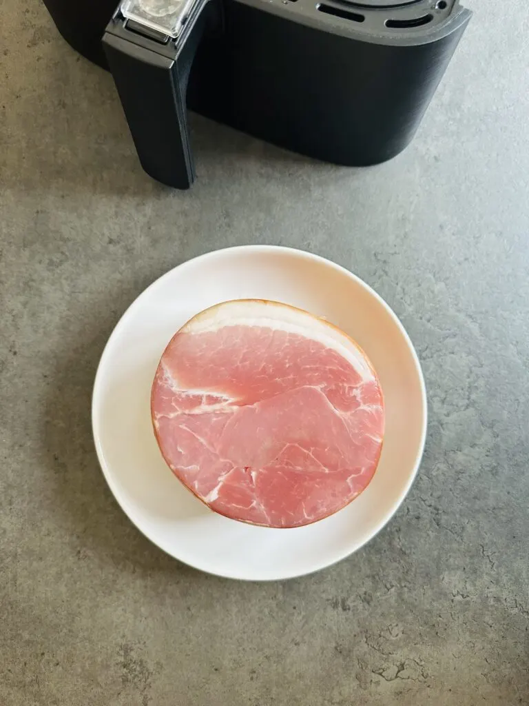 raw gammon next to air fryer