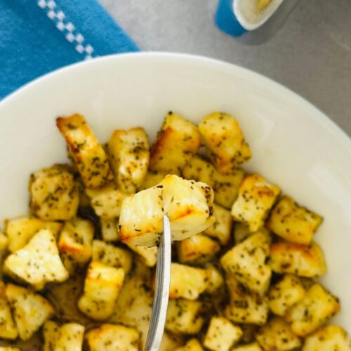 halloumi air fryer bites with one piece of halloumi on a fork