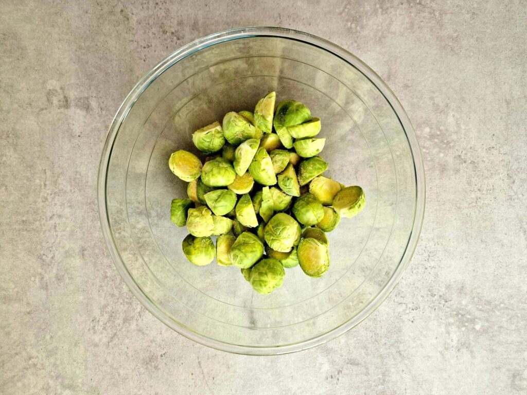 brussel sprouts in a bowl with garlic powder