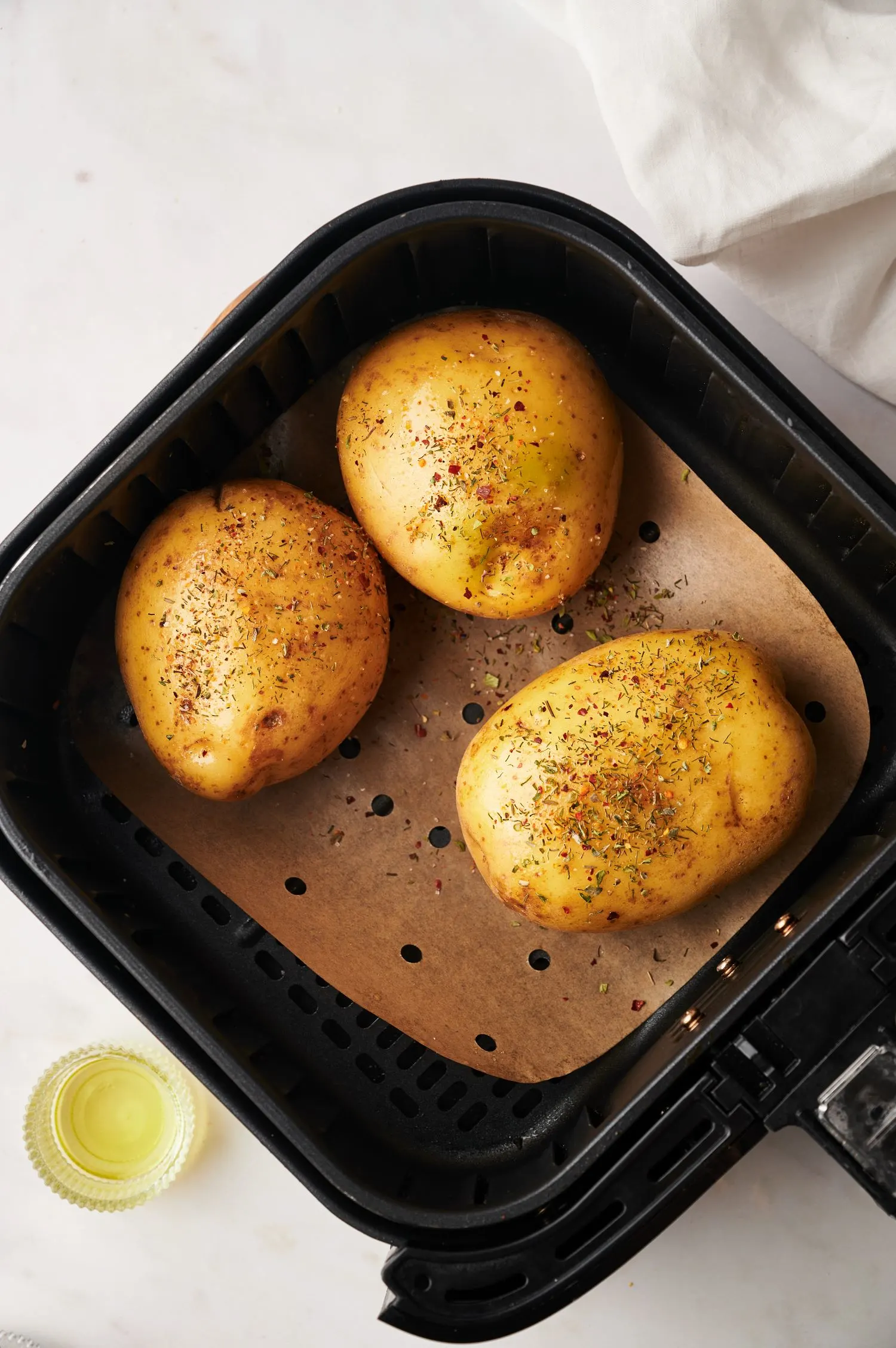 herbed baking potatoes in air fryer basket