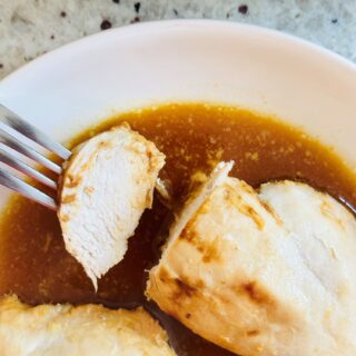 chicken breasts sliced on a fork in a honey and mustard sauce
