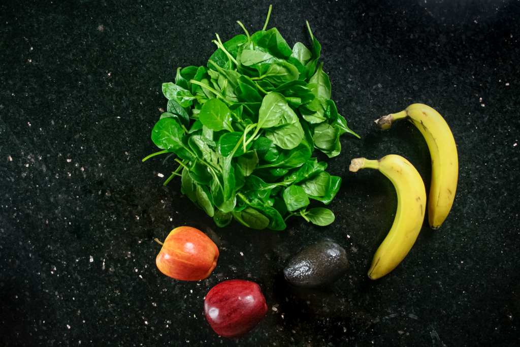 green smoothie ingredients laid out on worktop