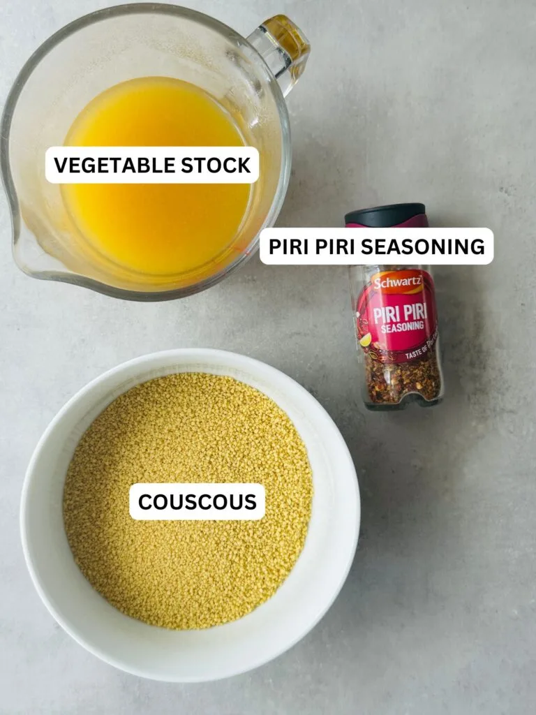 ingredients laid out for piri piri couscous: vegetable stock, piri piri seasoning, couscous
