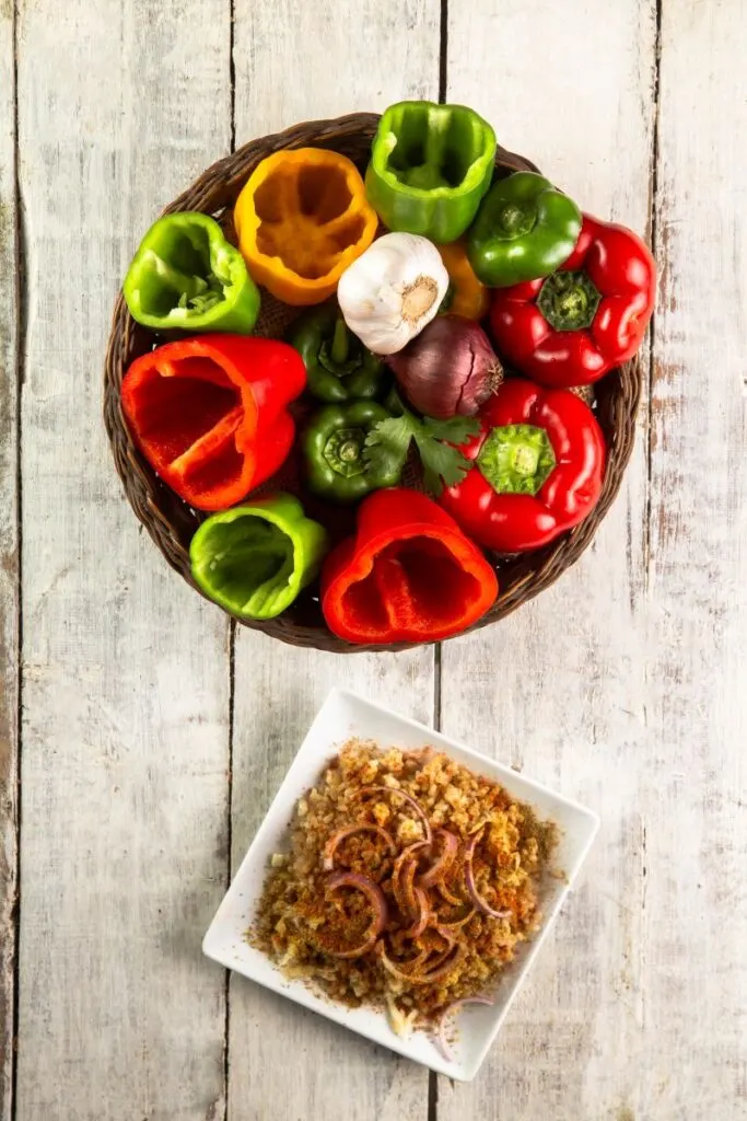 sweet peppers, garlic, onion and cooked rice in a bowl, prepared for the slow cooker. 