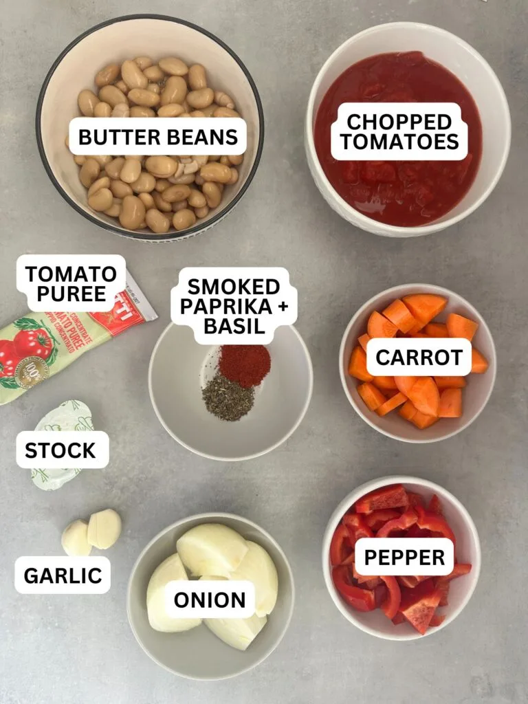 ingredients laid out and labelled for butter nut and tomato soup: butter beans, chopped tomatoes, tomato puree, smoked paprika, dried basil, carrot, stock, garlic, onion and pepper