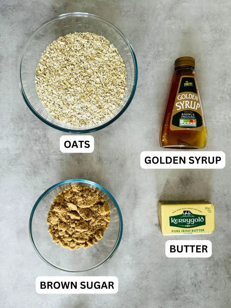 ingredients laid out for a traditional flapjack recipe: oats, golden syrup, brown sugar, butter