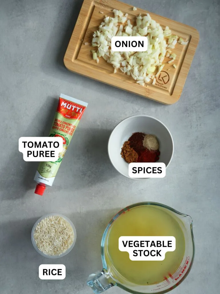 ingredients laid out and labelled for rice cooker Mexican style rice: onion, tomato puree, spices, rice and vegetable stock