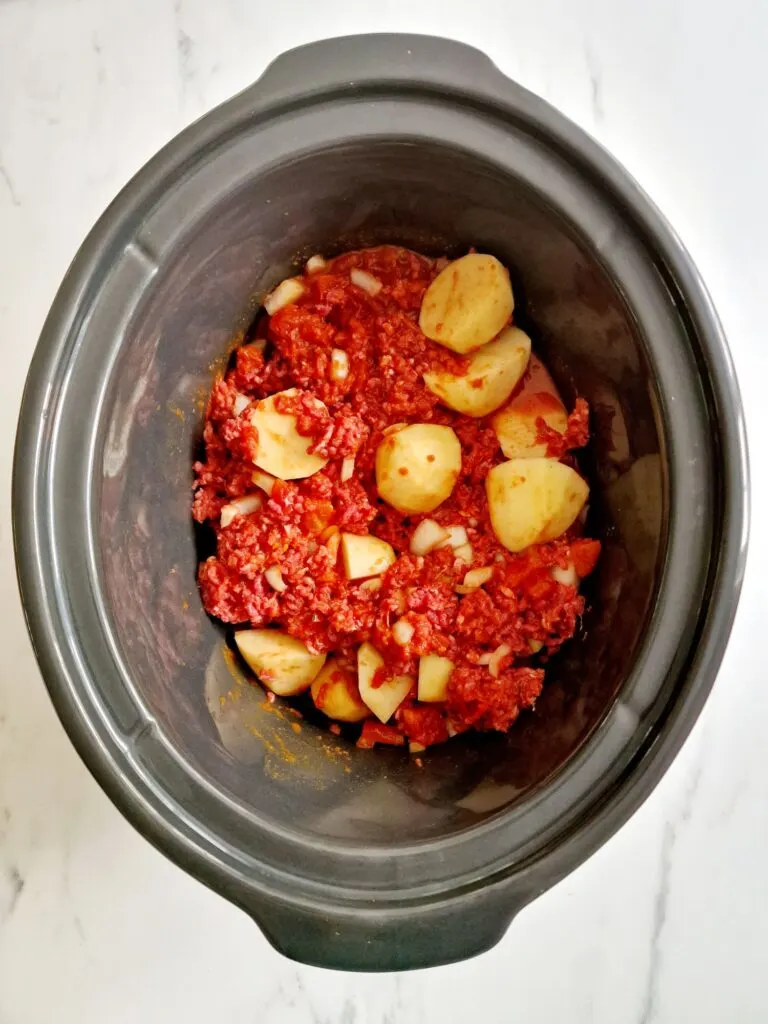 keema ingredients mixed together in slow cooker