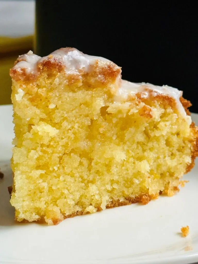 slice of lemon drizzle cake on a plate