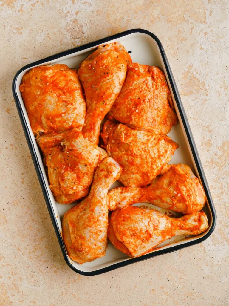 marinating chicken in Harissa paste