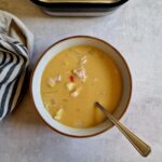 massaman inspired soup in a bowl next to a Ninja soup maker