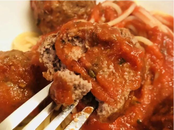 meatballs in sauce with spaghetti that have been cooked in an air fryer