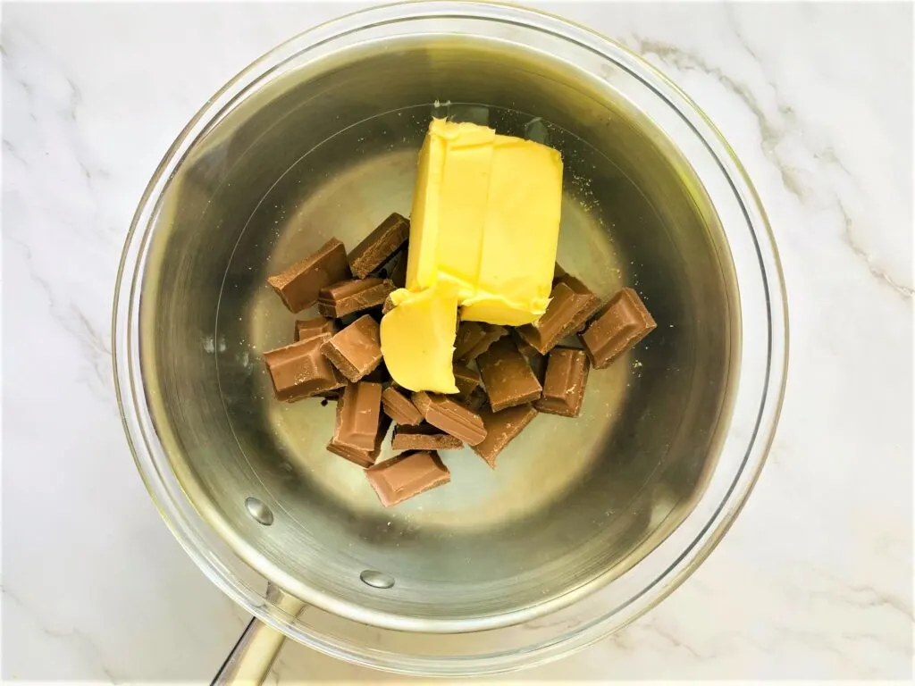 melt butter and chocolate in bowl over boiling water in saucepan