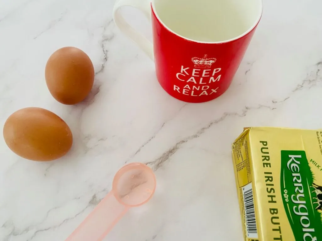 ingredients for microwave scrambled eggs, with a mug for cooking it in.