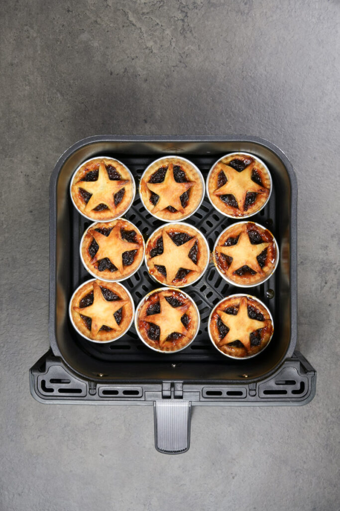 cooked mince pies in an air fryer basket