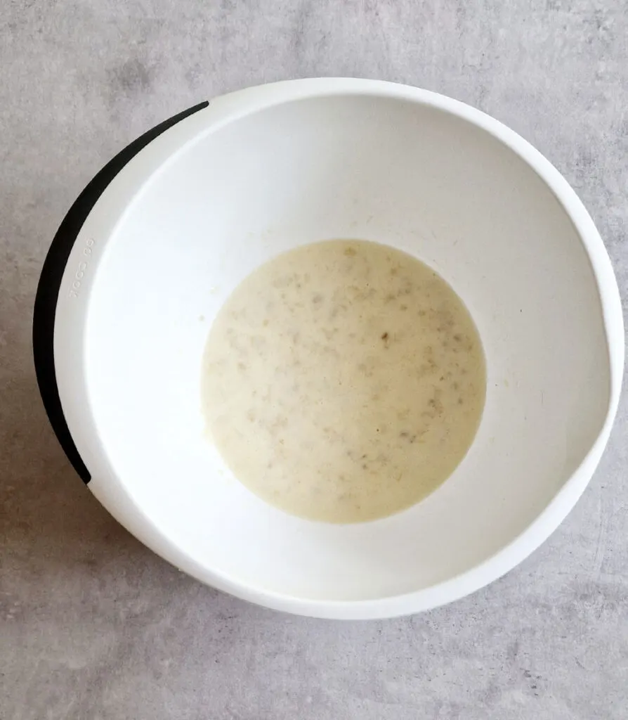 mashed banana mixed with flour egg milk and oil to make banana pancake batter