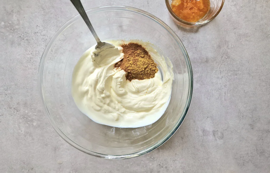 mixing curry powder with yoghurt to make Coronation Chicken sauce