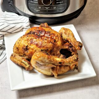 whole roast chicken next to a Ninja Foodi