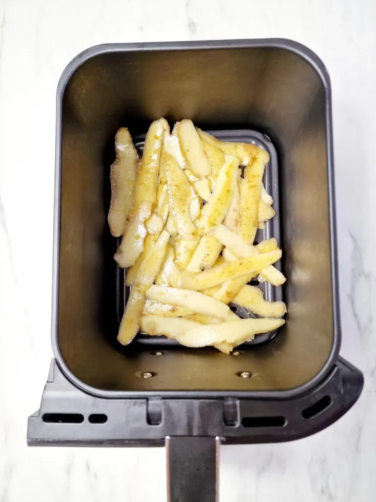 potato peelings in an air fryer basket