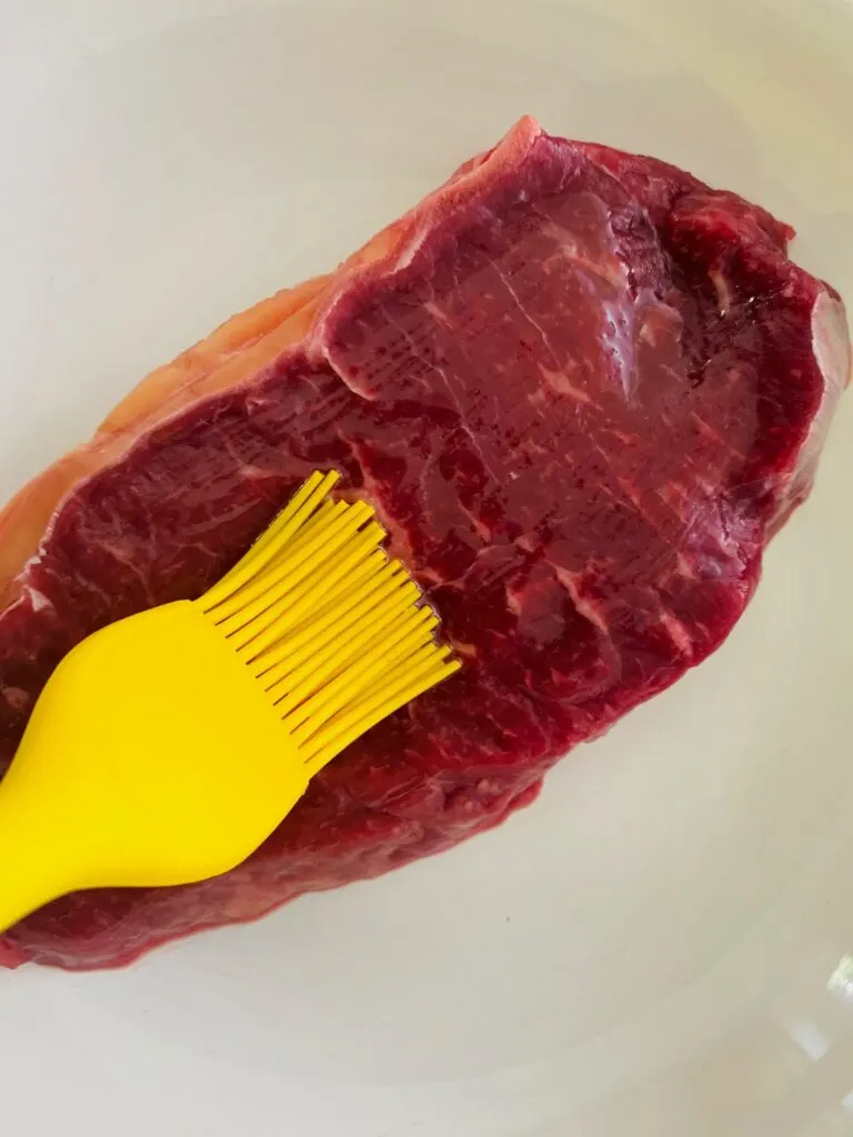 oiling a steak before air fryer