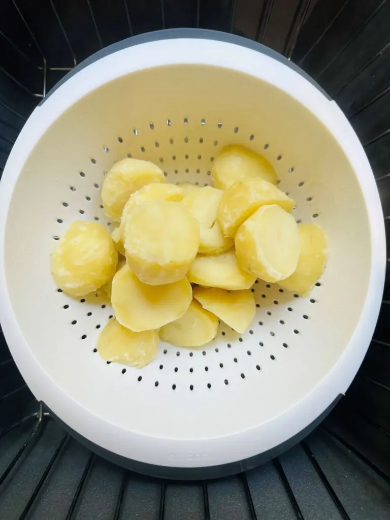 par boiled potatoes in colander