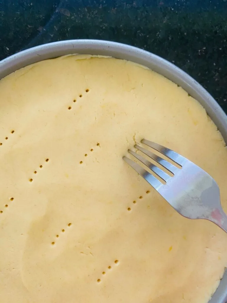 fork piercing holes in lemon shortbread dough