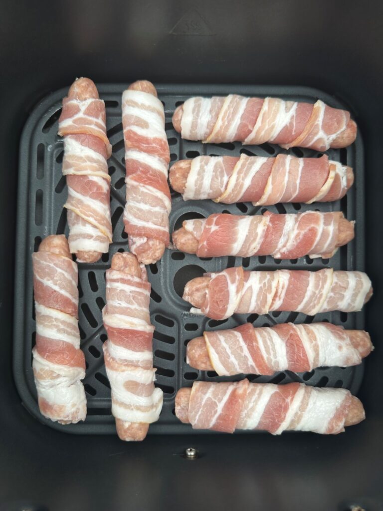 prepared pigs in blankets in the air fryer ready to be cooked
