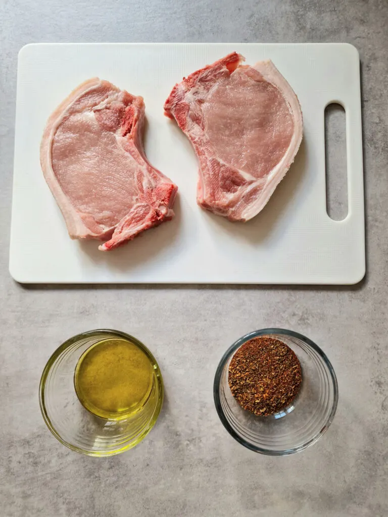 2 pork chops, oil, seasoning